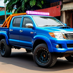 Modified Car in Kinshasa**

"A brightly colored Toyota Hilux, fully modified with large alloy rims and LED lights, parked on a street in Kinshasa, Congo. The car is fully clothed, safe for work, and appropriate content. Focus on the details of the modifications, showcasing the vibrant car culture. Background includes local street vendors and pedestrians in modest clothing. Professional photography, perfect anatomy, correct proportions, natural pose, high quality."

**